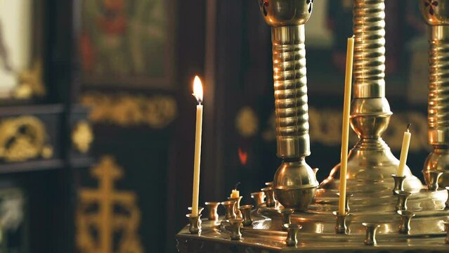 Lit candles in a Christian church close-up. Religious concept.