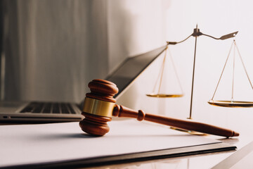 Justice and law concept.Male judge in a courtroom with the gavel, working with, computer and...