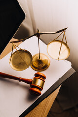 Justice and law concept.Male judge in a courtroom with the gavel, working with, computer and docking keyboard, eyeglasses, on table in morning light