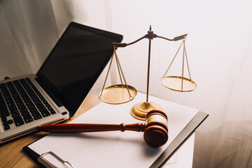 Justice and law concept.Male judge in a courtroom with the gavel, working with, computer and...