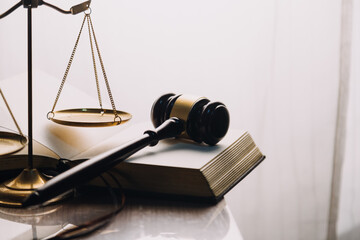 Justice and law concept.Male judge in a courtroom with the gavel, working with, computer and...