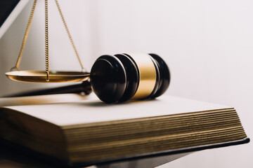 Justice and law concept.Male judge in a courtroom with the gavel, working with, computer and...