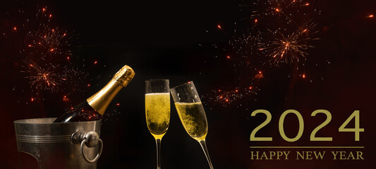 HAPPY NEW YEAR 2024 celebration holiday greeting card background banner panorama - Champagne or sparkling wine bottles, bucket and toasting clink glasses, firework in the night