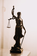 Justice and law concept.Male judge in a courtroom with the gavel, working with, computer and docking keyboard, eyeglasses, on table in morning light