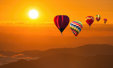 color hot air balloon in sky at sunrise time, Colorful hot-air balloons flying in orange sky and sunset. Sport, adventure, transportation,Travel.