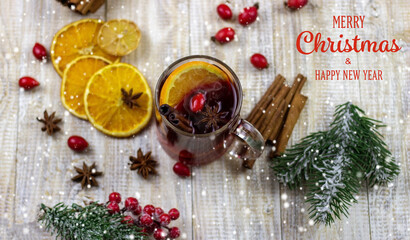 cups with hot mulled wine on a wooden background.