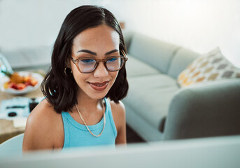 Confident young female worker with spectacles, working from home office alone in virtual team...