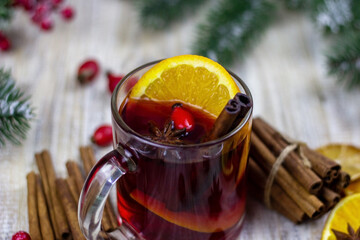 cups with hot mulled wine on a wooden background.