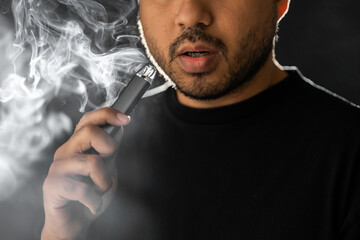 Close-up mouth of man smoke inhaling, breathing and smoke electronic cigarette.