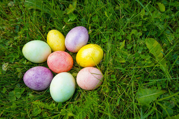 Multicolored eggs on the grass. Easter holiday tradition. Spring religious holiday.