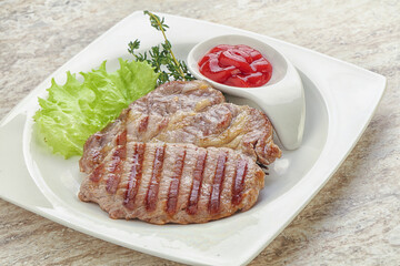 Grilled pork neck steak with ketchup