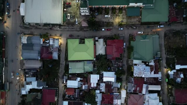 Cinematic aerial view of a small town center with small roads in the Philippines