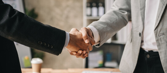 Two confident business man shaking hands during a meeting in the office, success, dealing, greeting and partner in sun light © Nuttapong punna