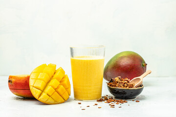 Yellow mango yogurt or smoothie with granola, Delicious breakfast or snack, vertical image. place for text