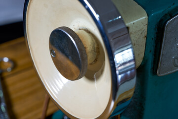 Close-up of the wheel of a traditional household sewing machine