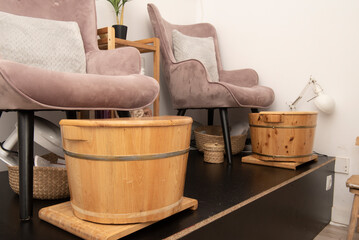 Pedicure treatment area with half-barrels of pine wood in an aesthetic center