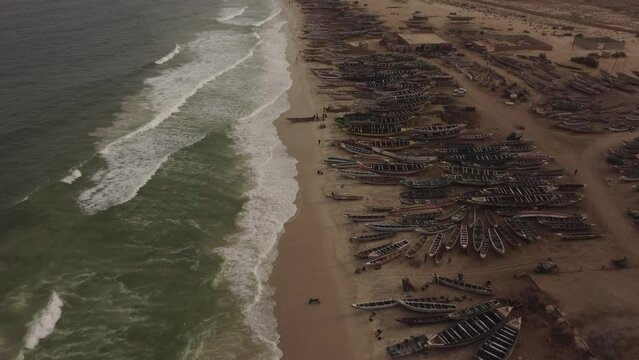 Drone shot moving along the coast of the Nouakchott fish port, the Port peche.