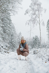 Winter.woman walks through winter snowy forest. Mental and physical health. Unity with nature.travel outdoors, hiking, spending time outdoors,winter travel,slow life,christmas forest.