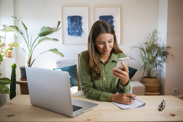 Woman procrastinating on social media while working from home