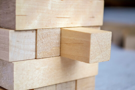 Board game Tower close-up. Wooden blocks are stacked on top of each other. The tower is made of wooden elements. Board game Tower made of wood.