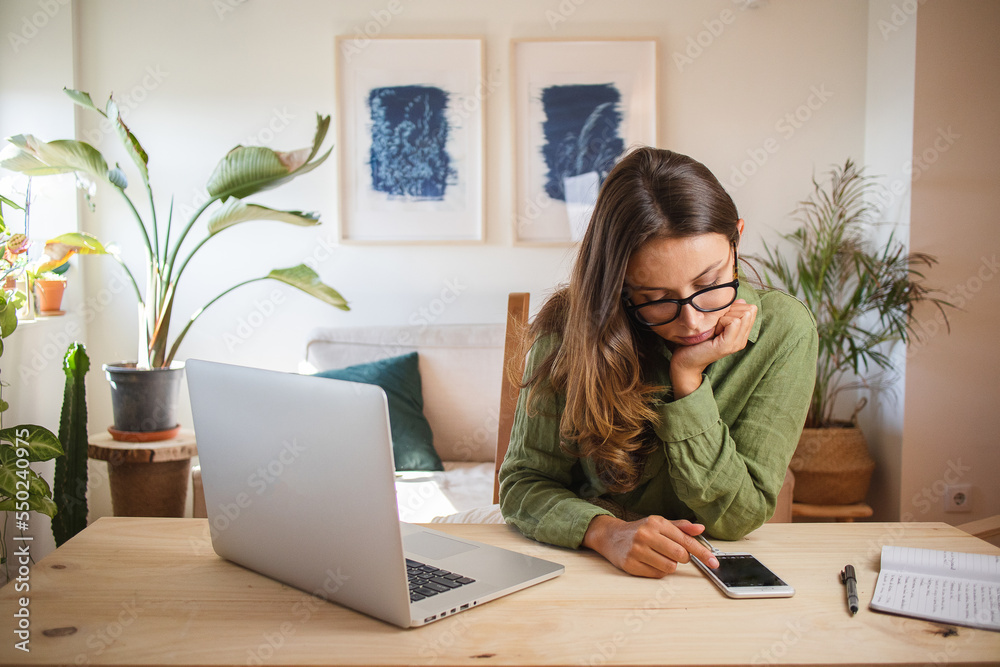 Wall mural woman bored and procrastinating working from home