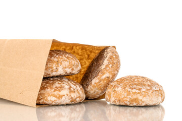 Several sweet tasty gingerbread cookies with paper bag, macro, isolated on white background.