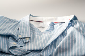 Partial closeup of a light blue striped shirt