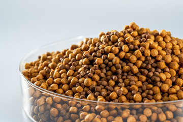 Closeup of a pile of fresh fish feed pellets