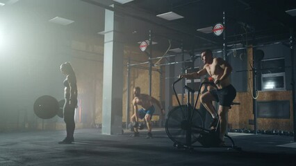 powerlifters training in gym, group of adult attractive men and women doing exercise for good body