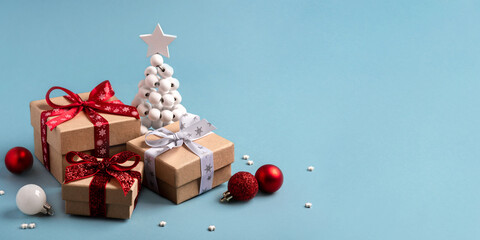 Gift boxes with Christmas decorations on blue background. Front view.