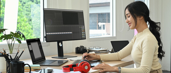 Image of female video editor working with footage and post production montage in creative office...