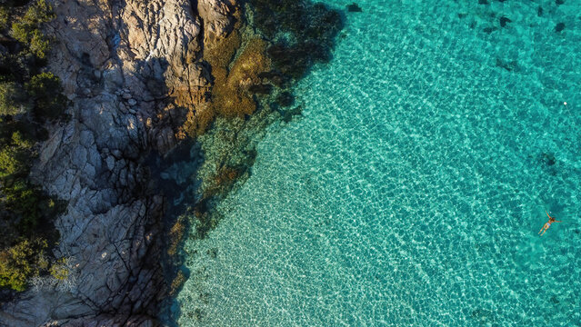 Colorful beach and sea in summer colours. Coast from aerial view. Exclusive landscape scene from nature. Waves, blue water, gold sand, turquoise shore, rocks, stones, premium exotic background © Simon Vasut