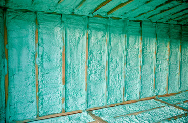 Wooden frame house thermal insulated by polyurethane foam. Construction and insulation concept.