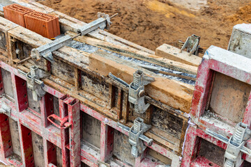 Reinforced concrete foundation of a modern monolithic residential building. Prepared formwork with reinforcing mesh for pouring concrete. Monolithic construction technologies.