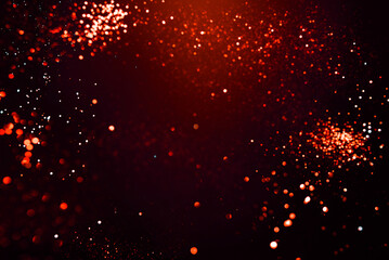 Red abstract bokeh on black background. Holiday concept