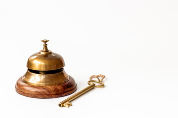 Fototapeta na wymiar Vintage golden hotel service bell with key
