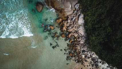 Colorful beach and sea in summer colours. Coast from aerial view. Exclusive landscape scene from nature. Waves, blue water, gold sand, turquoise shore, rocks, stones, premium exotic background
