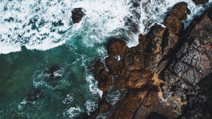 Colorful beach and sea in summer colours. Coast from aerial view. Exclusive landscape scene from nature. Waves, blue water, gold sand, turquoise shore, rocks, stones, premium exotic background