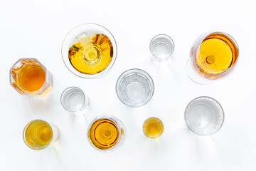 Alcoholic drinks in glasses with ice. Strong alcohol background