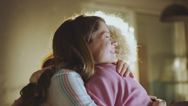 Portrait of gynecologist hugging young pregnant woman and smiling. Caucasian expert professional gynecologist supporting expectant consulting patient