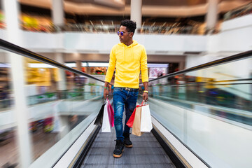 Man in escalator of a shopping mall