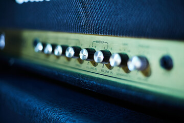 Guitar amplifier, level knobs closeup shot. Electric guitar amp closeup photo for rock music. 
