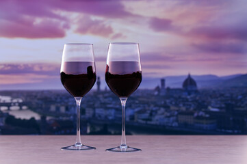 Glass of two red wine with view of sunset over Florence downtown