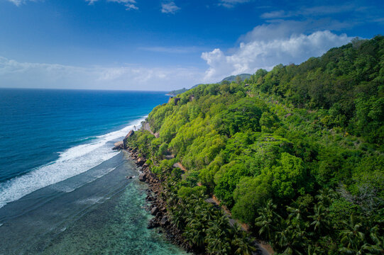 Drone View Over lush Coast of Praslin Island, Seychelles