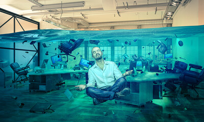 man in floating meditation in a flooded office.