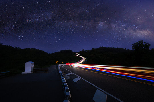  long exposure shot  car light at night scene blue sky and galaxy or star milky way background, at Curved Road No.3 or Route No.1081 over top of mountains 