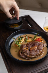 delicious fried steak in sauce in a restaurant
