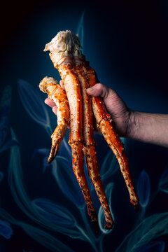 The cook holds a phalanx of crab in his hand