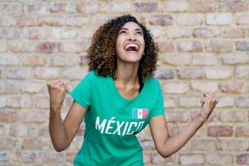 Naklejka na ściany i meble Cheering mexican woman loves the national soccer team