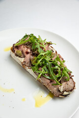 delicious bruschetta with cheese, meat, vegetables in a restaurant
